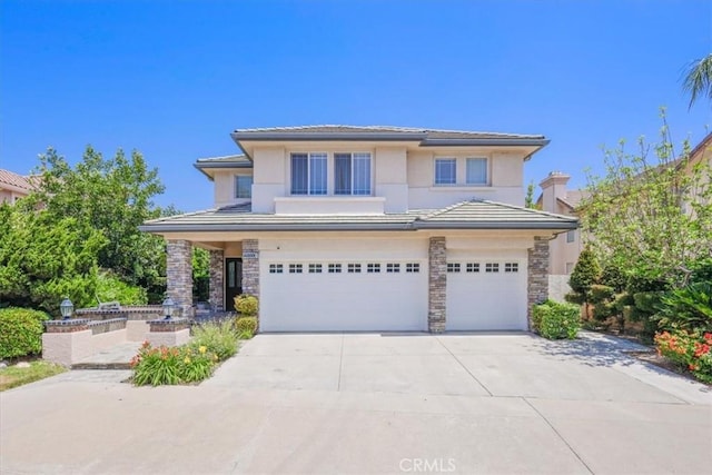 20333 Wynfreed Ln, Porter Ranch, CA 91326 - prairie-style home with an attached garage, concrete driveway, stone siding, stucco siding, and a tile roof