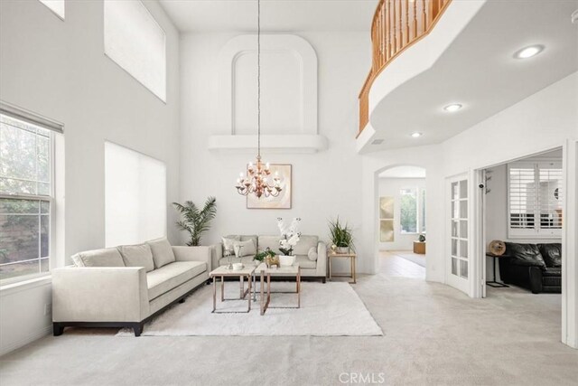 20333 Wynfreed Ln, Porter Ranch, CA 91326 - living area with light colored carpet, a towering ceiling, arched walkways, and a chandelier