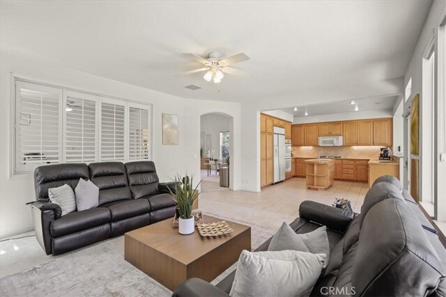 20333 Wynfreed Ln, Porter Ranch, CA 91326 - living room with arched walkways, ceiling fan, and baseboards