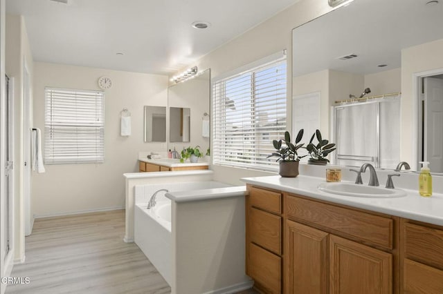 371 Huerta St, Oxnard, CA 93030 - bathroom with vanity, a garden tub, and wood finished floors