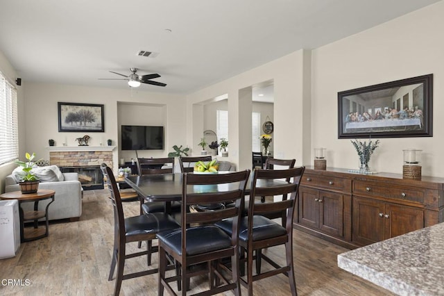 371 Huerta St, Oxnard, CA 93030 - dining space with a ceiling fan, dark wood-style floors, and a stone fireplace