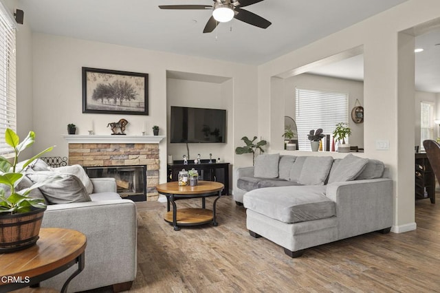 371 Huerta St, Oxnard, CA 93030 - living room with ceiling fan, wood finished floors, and a stone fireplace