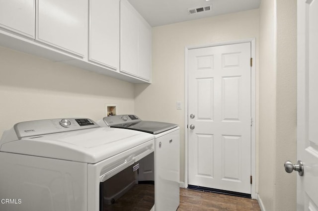 371 Huerta St, Oxnard, CA 93030 - laundry room with separate washer and dryer, dark wood finished floors, and cabinet space