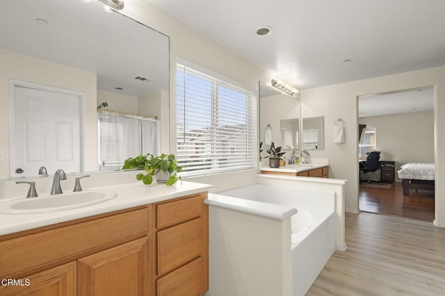 371 Huerta St, Oxnard, CA 93030 - bathroom with wood finished floors, ensuite bathroom, a garden tub, vanity, and a shower stall