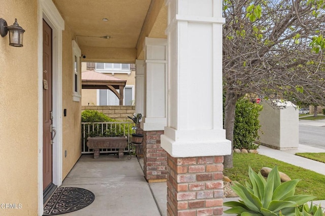 371 Huerta St, Oxnard, CA 93030 - doorway to property featuring a porch, brick siding, and stucco siding