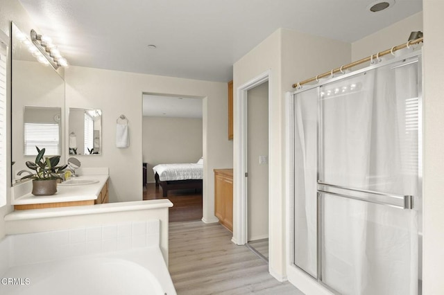 371 Huerta St, Oxnard, CA 93030 - ensuite bathroom with wood finished floors, curtained shower, vanity, and a bathtub