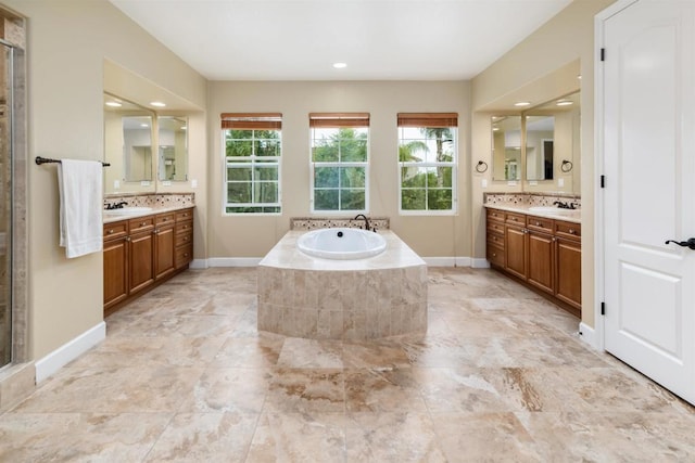 6851 Helenite Pl, Carlsbad, CA 92009 - bathroom featuring two vanities, a bath, a stall shower, baseboards, and recessed lighting