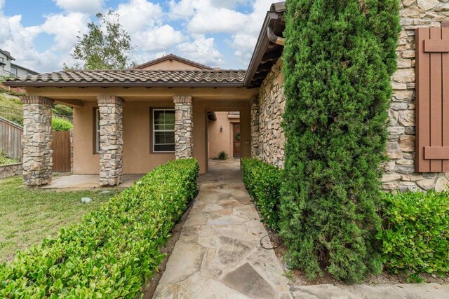 6851 Helenite Pl, Carlsbad, CA 92009 - view of front facade featuring stone siding and a tiled roof