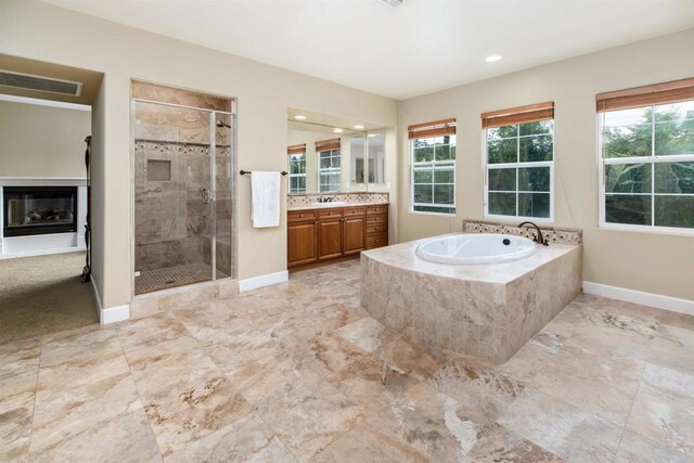 6851 Helenite Pl, Carlsbad, CA 92009 - bathroom featuring vanity, baseboards, a shower stall, a garden tub, and recessed lighting