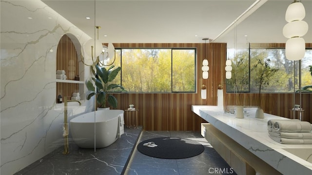 11464 Canton Dr, Studio City, CA 91604 - bathroom with a freestanding bath, double vanity, marble tiled flooring, and stone wall