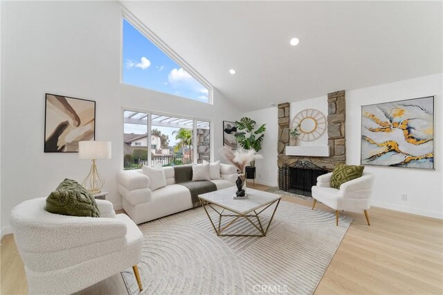 16247 Elza Dr, Hacienda Heights, CA 91745 - living room with high vaulted ceiling, wood finished floors, baseboards, a stone fireplace, and recessed lighting