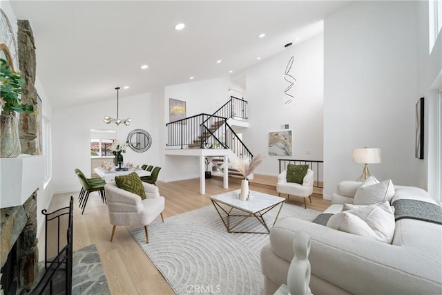 16247 Elza Dr, Hacienda Heights, CA 91745 - living room featuring light wood-style floors, high vaulted ceiling, stairway, a chandelier, and recessed lighting