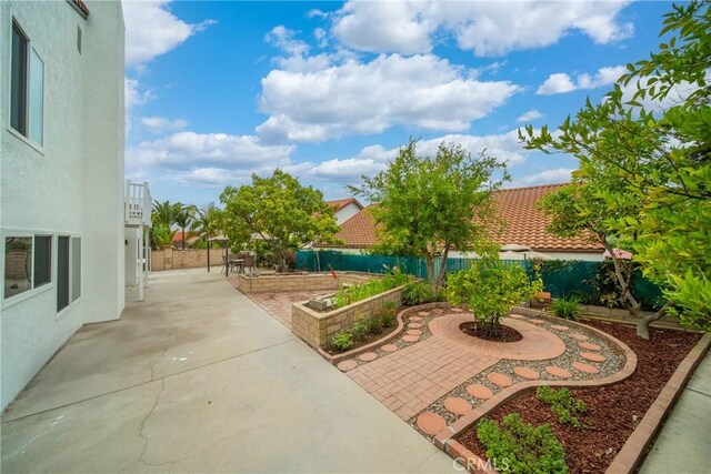 16247 Elza Dr, Hacienda Heights, CA 91745 - fenced backyard featuring a patio and a vegetable garden