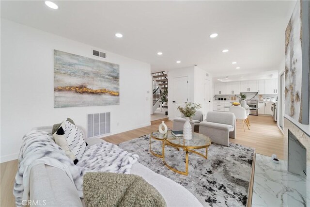 16247 Elza Dr, Hacienda Heights, CA 91745 - living room with stairway, recessed lighting, light wood finished floors, and baseboards