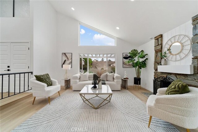 16247 Elza Dr, Hacienda Heights, CA 91745 - living room with wood finished floors, high vaulted ceiling, baseboards, and a fireplace