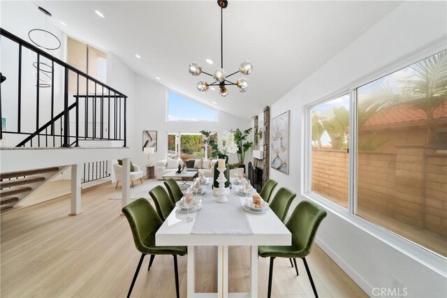 16247 Elza Dr, Hacienda Heights, CA 91745 - dining area with light wood-style floors, stairway, a chandelier, recessed lighting, and high vaulted ceiling