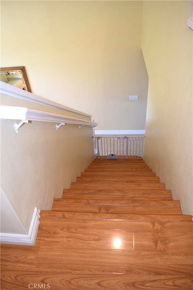 920 Nettle Ct, Corona, CA 92878 - staircase with baseboards and wood finished floors