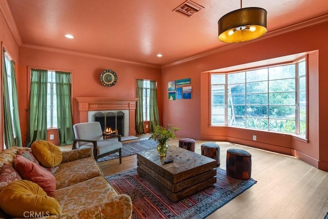 1131 S Vicentia Ave, Corona, CA 92882 - living room featuring ornamental molding, wood finished floors, a lit fireplace, and recessed lighting