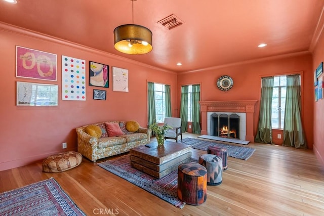 1131 S Vicentia Ave, Corona, CA 92882 - living area with crown molding, wood finished floors, a lit fireplace, recessed lighting, and baseboards