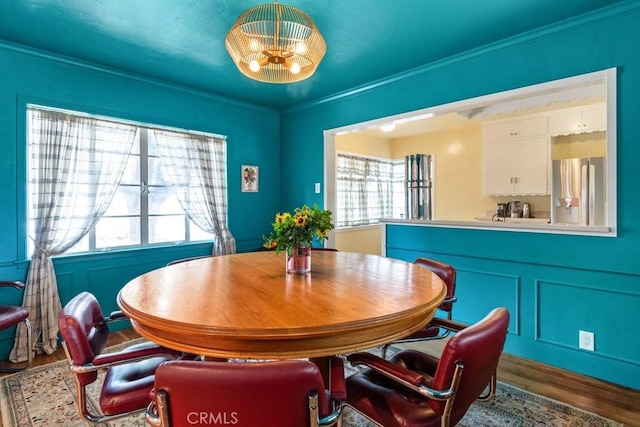 1131 S Vicentia Ave, Corona, CA 92882 - dining space featuring wood finished floors, a chandelier, and ornamental molding