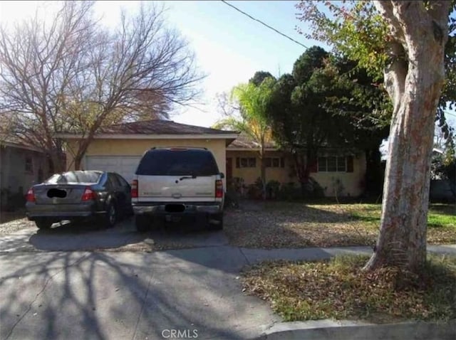 1111 E 27th St, San Bernardino, CA 92404 - view of front of house with driveway and an attached garage
