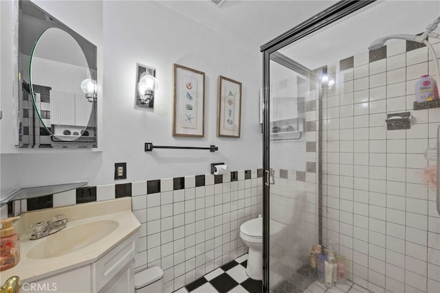 19518 Nancy Cir, Cerritos, CA 90703 - bathroom with a stall shower, toilet, vanity, tile walls, and a wainscoted wall