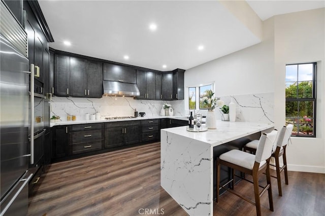 2545 Scenic Ridge Dr, Chino Hills, CA 91709 - kitchen with under cabinet range hood, a peninsula, plenty of natural light, backsplash, and recessed lighting