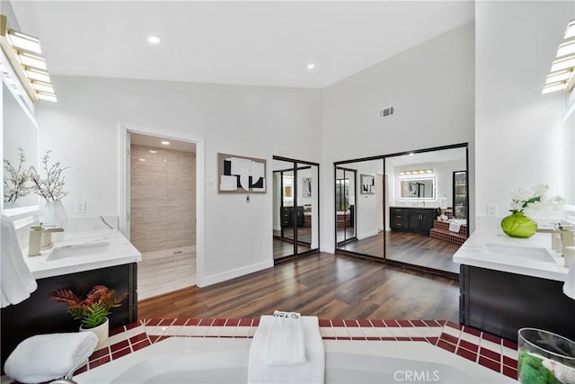 2545 Scenic Ridge Dr, Chino Hills, CA 91709 - living area featuring wood finished floors, high vaulted ceiling, recessed lighting, plenty of natural light, and baseboards