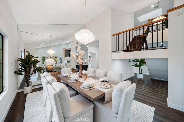 2545 Scenic Ridge Dr, Chino Hills, CA 91709 - dining space featuring a chandelier, a towering ceiling, stairway, wood finished floors, and baseboards