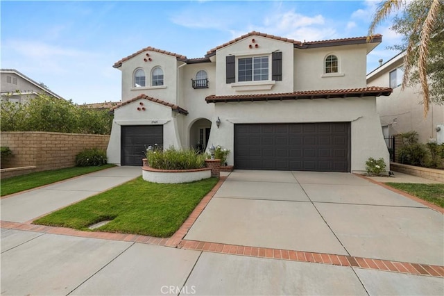 27625 Mariposa Ln, Castaic, CA 91384 - mediterranean / spanish house with an attached garage, concrete driveway, a tiled roof, and stucco siding