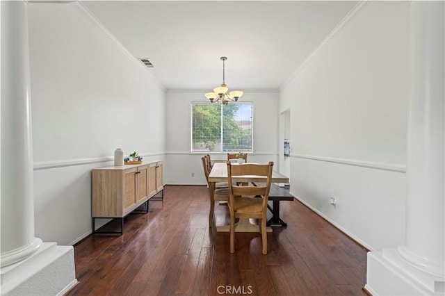 27625 Mariposa Ln, Castaic, CA 91384 - dining room featuring crown molding, a chandelier, dark wood-type flooring, and decorative columns