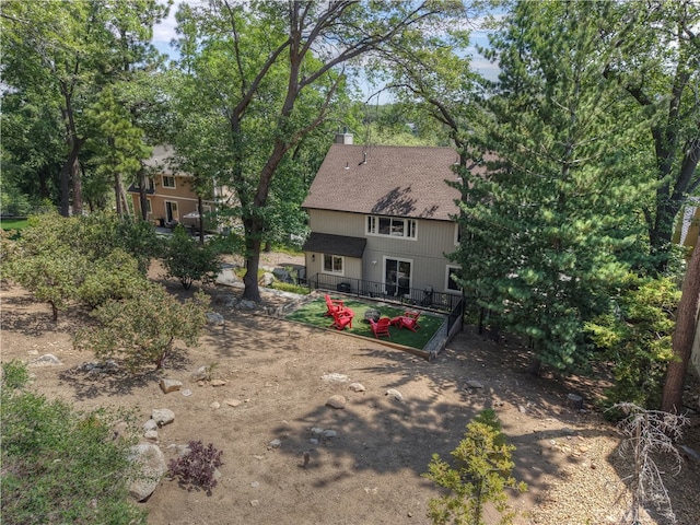 942 Lucerne Ln, Lake Arrowhead, CA 92352 - rear view of house featuring a chimney, a shingled roof, and view of scattered trees
