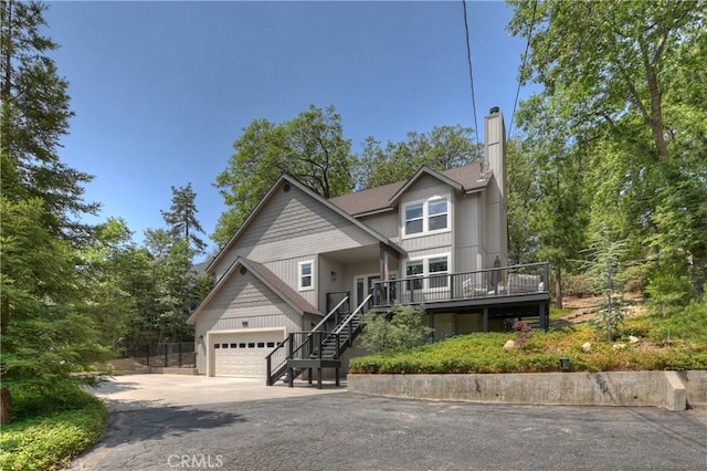 942 Lucerne Ln, Lake Arrowhead, CA 92352 - view of front of house featuring stairway, driveway, a garage, and a chimney
