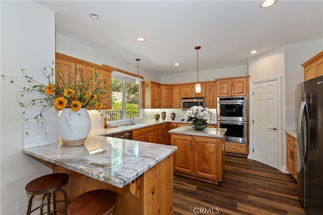942 Lucerne Ln, Lake Arrowhead, CA 92352 - kitchen featuring appliances with stainless steel finishes, a peninsula, tasteful backsplash, dark wood finished floors, and recessed lighting