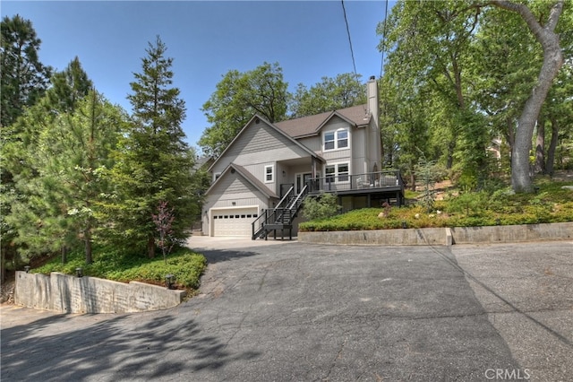 942 Lucerne Ln, Lake Arrowhead, CA 92352 - view of front facade with stairs, driveway, a garage, a chimney, and a porch