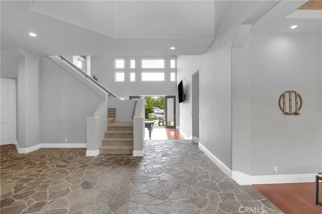 7 Olympic Way, Coto De Caza, CA 92679 - foyer entrance featuring stone flooring, recessed lighting, stairs, and a towering ceiling