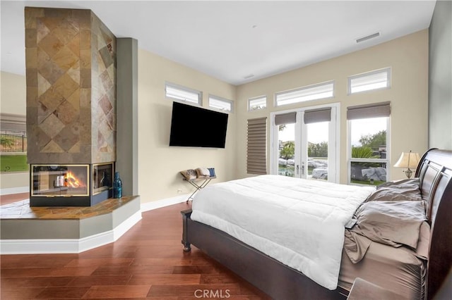 7 Olympic Way, Coto De Caza, CA 92679 - bedroom with a fireplace, wood finished floors, access to outside, and multiple windows