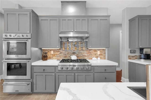 7 Olympic Way, Coto De Caza, CA 92679 - kitchen with gray cabinets, appliances with stainless steel finishes, a warming drawer, and extractor fan