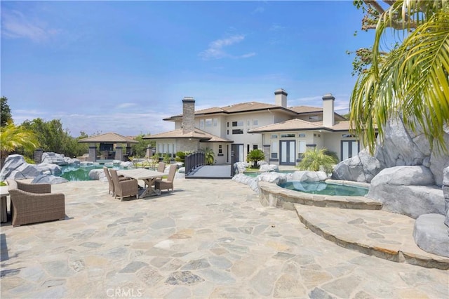 7 Olympic Way, Coto De Caza, CA 92679 - swimming pool with an in-ground hot tub, french doors, and a patio area