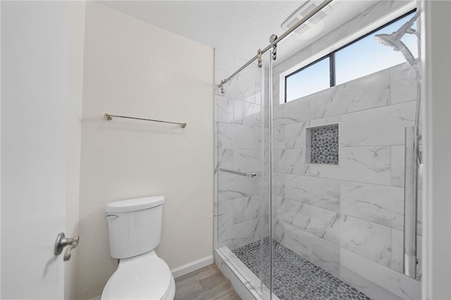 2712 Boundary Ln, Riverside, CA 92503 - full bath with toilet, a stall shower, baseboards, wood finished floors, and a textured ceiling