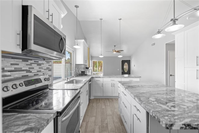 2712 Boundary Ln, Riverside, CA 92503 - kitchen featuring stainless steel appliances, a sink, tasteful backsplash, light wood-type flooring, and white cabinets