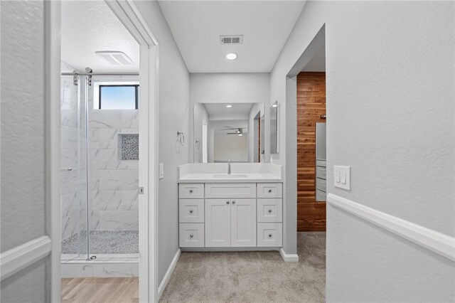 2712 Boundary Ln, Riverside, CA 92503 - full bath with a marble finish shower, vanity, baseboards, a textured wall, and ceiling fan