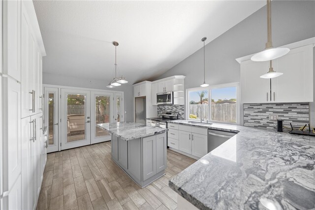 2712 Boundary Ln, Riverside, CA 92503 - kitchen featuring stainless steel appliances, backsplash, a sink, light stone counters, and white cabinetry