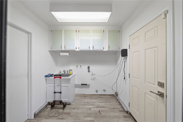 2712 Boundary Ln, Riverside, CA 92503 - laundry room featuring cabinet space, light wood-style flooring, and washer hookup
