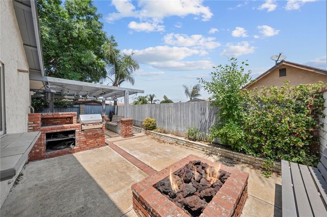2712 Boundary Ln, Riverside, CA 92503 - fenced backyard with a fire pit, a patio area, and a grill