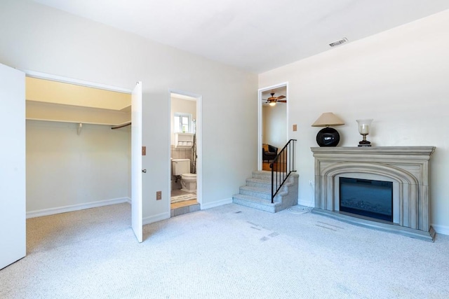 2033 Winnett St, San Diego, CA 92114 - unfurnished living room with carpet, stairs, ceiling fan, and a glass covered fireplace