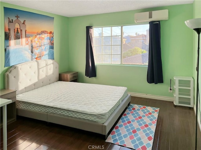 3855 Gilman Rd, El Monte, CA 91732 - bedroom with wood finished floors, a wall unit AC, and baseboards