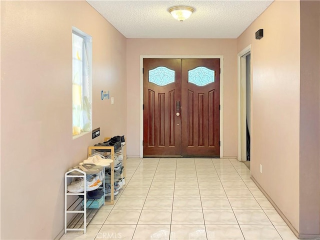 3855 Gilman Rd, El Monte, CA 91732 - entrance foyer with a textured ceiling, plenty of natural light, and light tile patterned floors