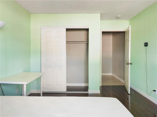 3855 Gilman Rd, El Monte, CA 91732 - unfurnished bedroom featuring wood finished floors, a closet, baseboards, and a textured ceiling