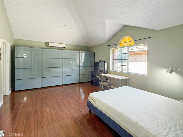 3855 Gilman Rd, El Monte, CA 91732 - bedroom featuring a wall mounted AC, lofted ceiling, wood finished floors, and a textured ceiling